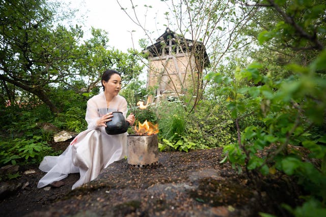 Designer Jihae Hwang in her Korean-inspired garden, A Letter From a Million Years Past, during the RHS Chelsea Flower Show press day at the Royal Hospital Chelsea, London (James Manning/PA)