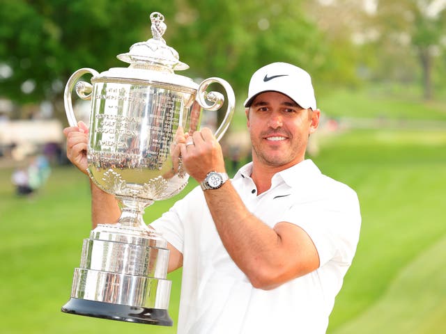 <p>Brooks Koepka in Rochester, New York, on Sunday lifts the Wanamaker Trophy for a third time</p>