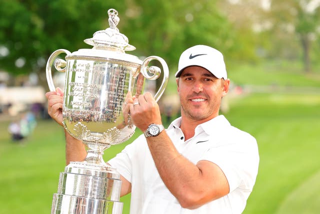 <p>Brooks Koepka in Rochester, New York, on Sunday lifts the Wanamaker Trophy for a third time</p>