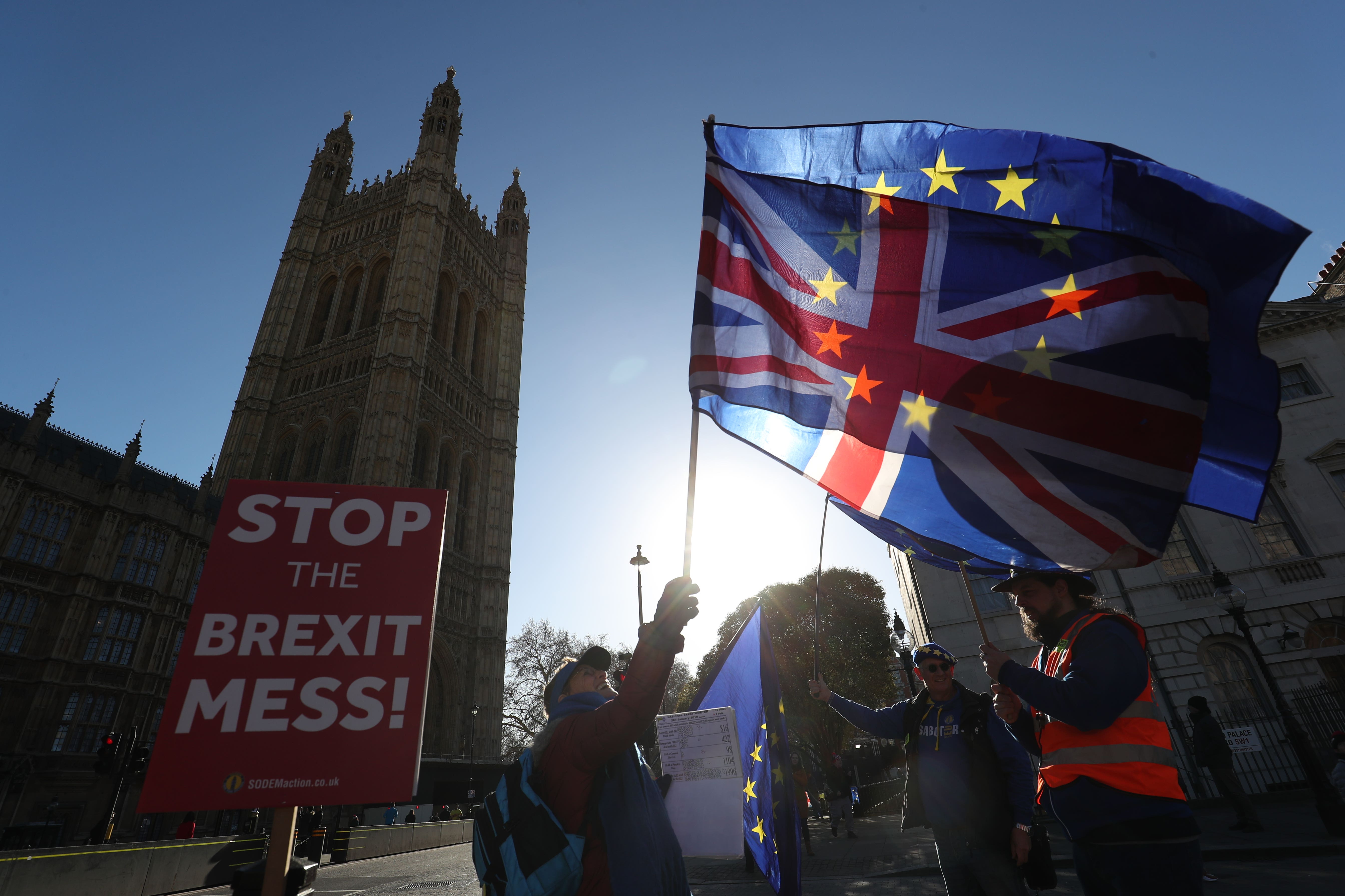 Anti-Brexit campaigners outside the Houses of Parliament in London (Jonathan Brady/PA)