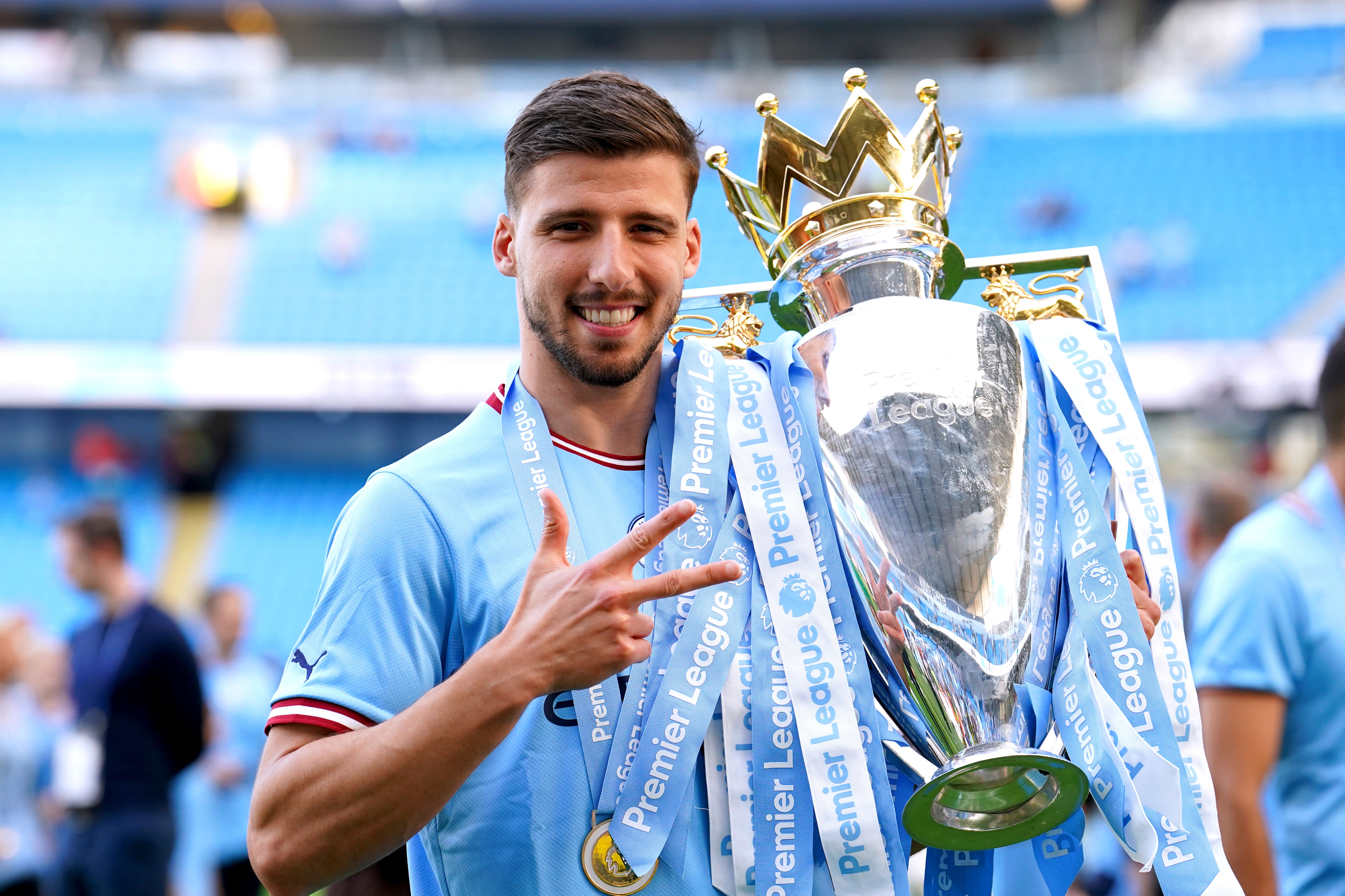 Ruben Dias celebrates with the Premier League trophy (Martin Rickett/PA)