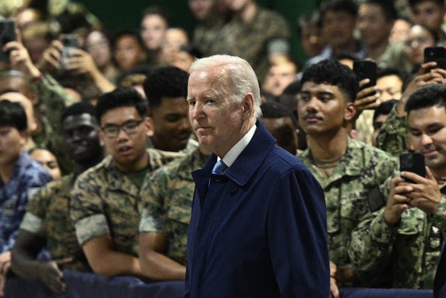<p>US president Joe Biden (left) greets US soldiers arriving to attend the G7 Summit at the US Marine Corps base in Iwakuni on 18 May 2023</p>