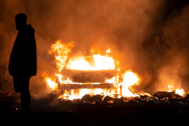 <p>A vehicle burns during unrest following a serious road crash earlier on Snowden Road on May 23, 2023 in Cardiff, Wales</p>