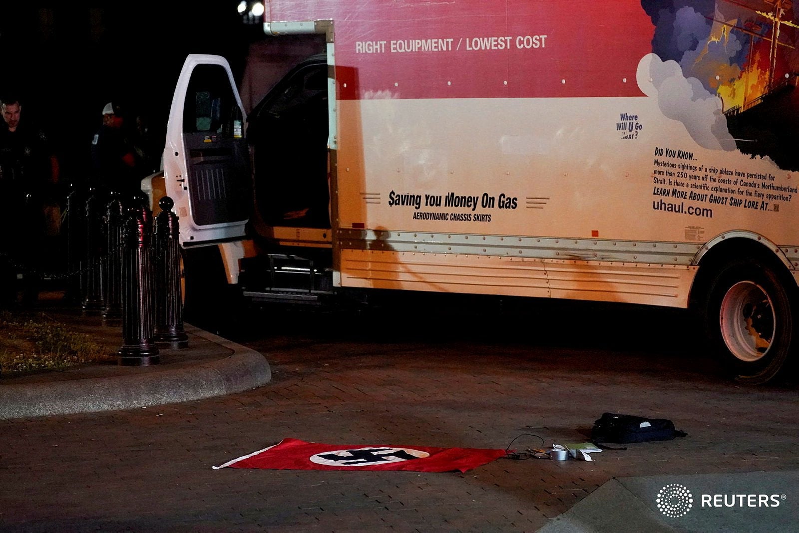 <p>A Nazi flag is seen on the ground outside the U-haul van </p>