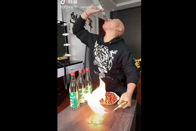 <p>Chinese Douyin user drinking alcohol during livestream </p>