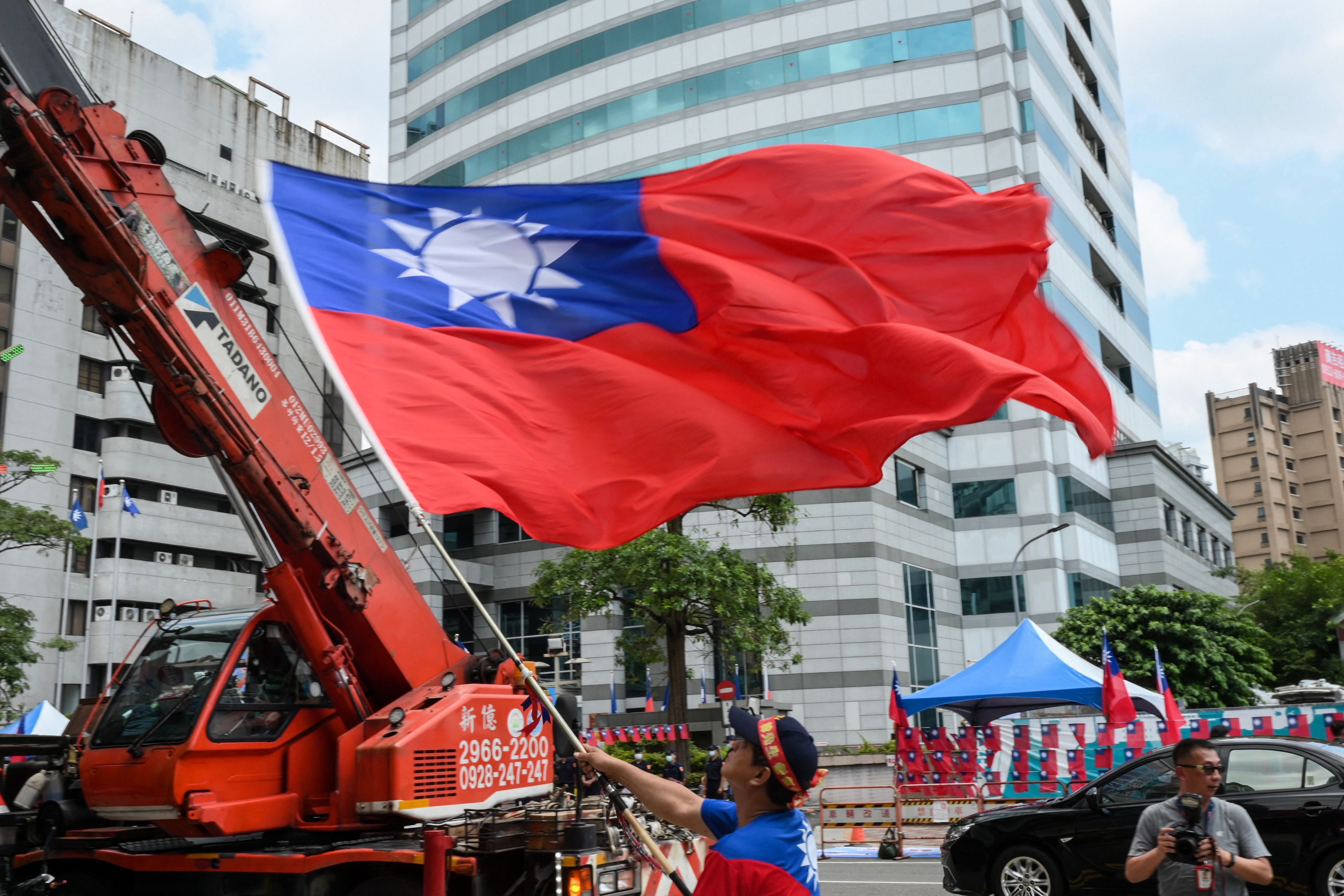 A man waves a Taiwanese flag during a rally
