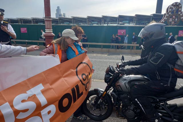 <p>A motorcyclist tried to drive through the group of demonstrators (Just Stop Oil/PA)</p>