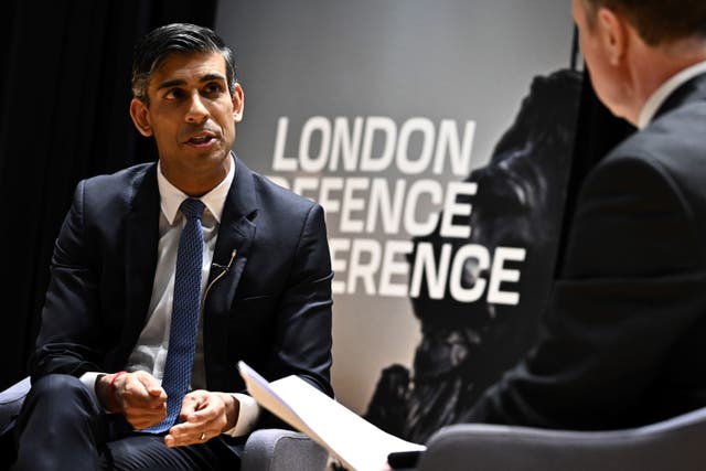 Prime Minister Rishi Sunak speaks with director of the London Defence Conference Iain Martin during the conference at Bush House, London (Ben Stansall/PA)
