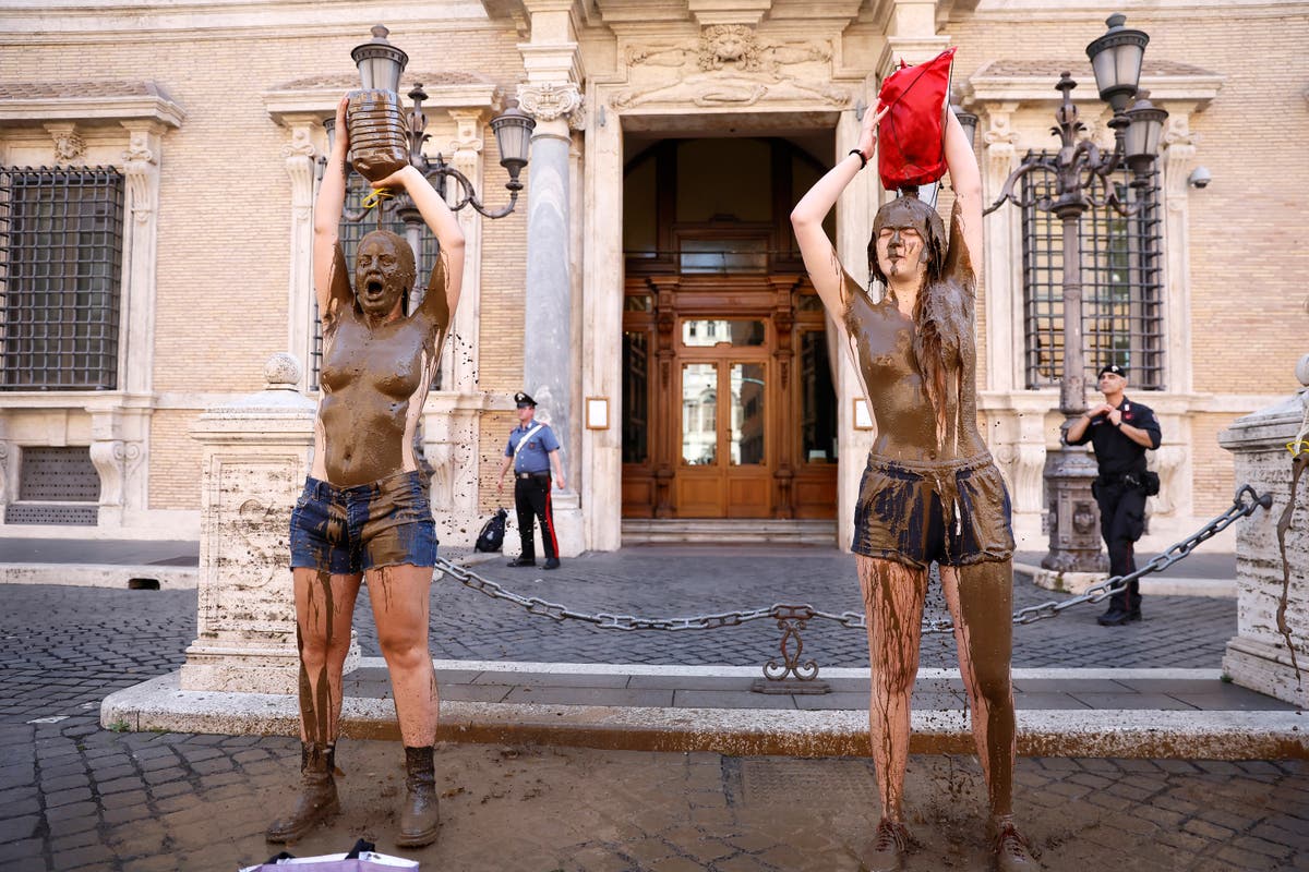 Climate activists smear themselves with mud to evoke flooding in Italy