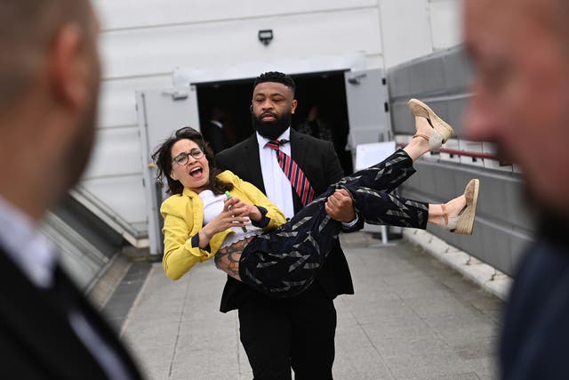 <p> A protester is carried out of the Shell annual general shareholders meeting in London on Tuesday </p>