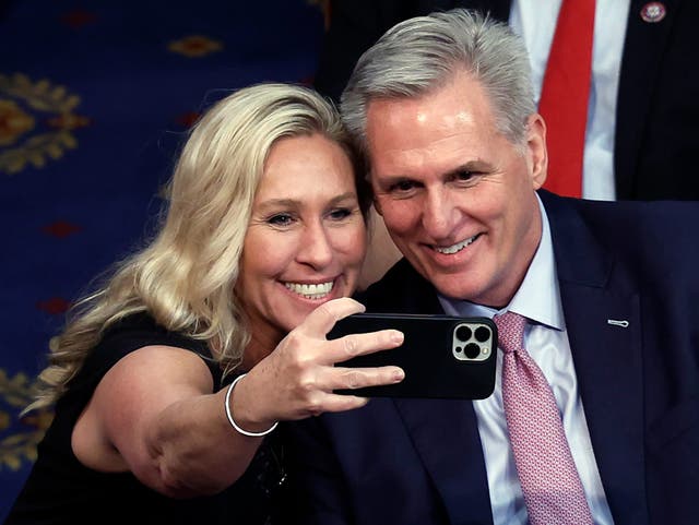 <p>Marjorie Taylor Greene takes a photo with Kevin McCarthy after he was elected Speaker of the House in February </p>