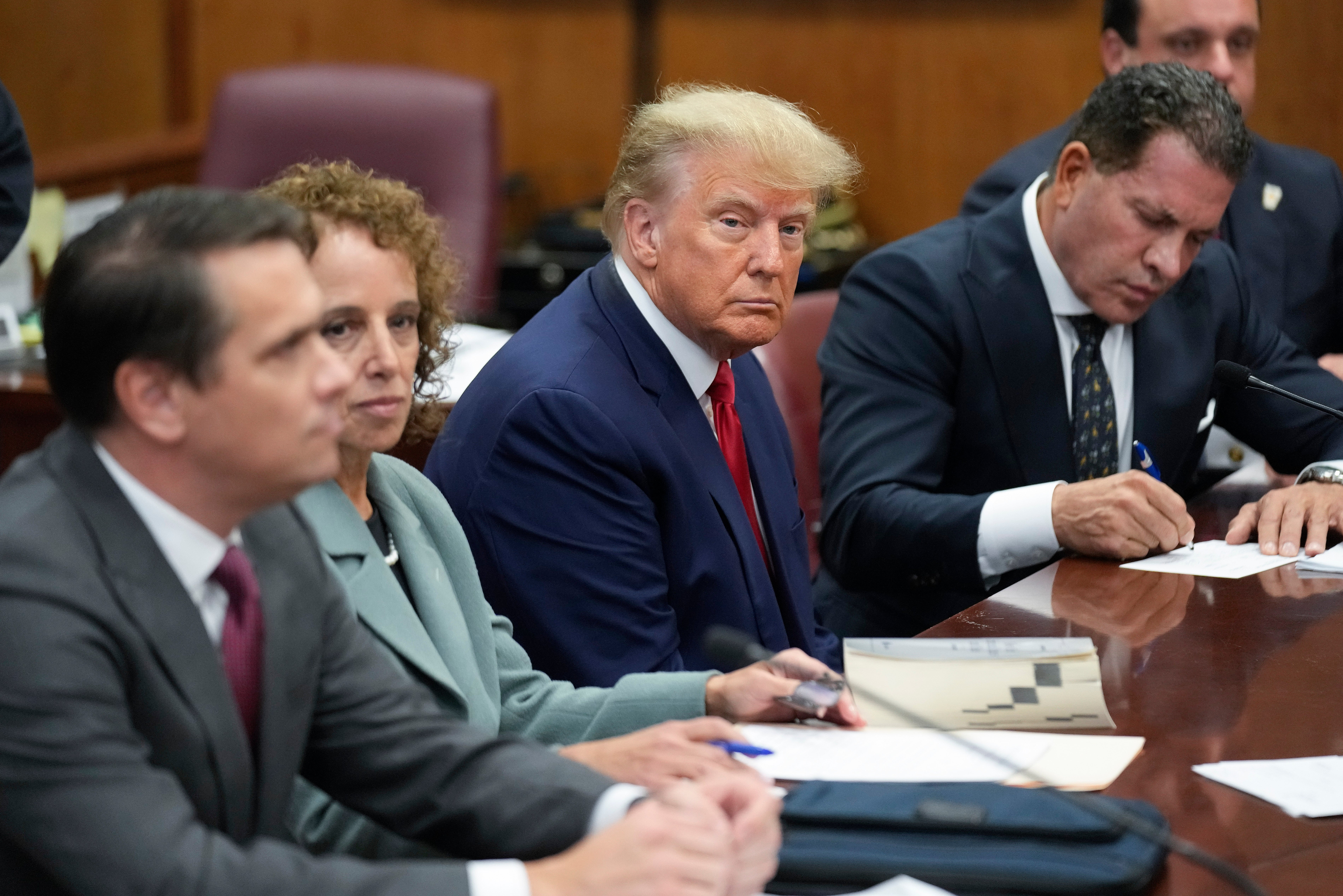 Mr Trump sits at the defence table with his legal team in a Manhattan court in April last year