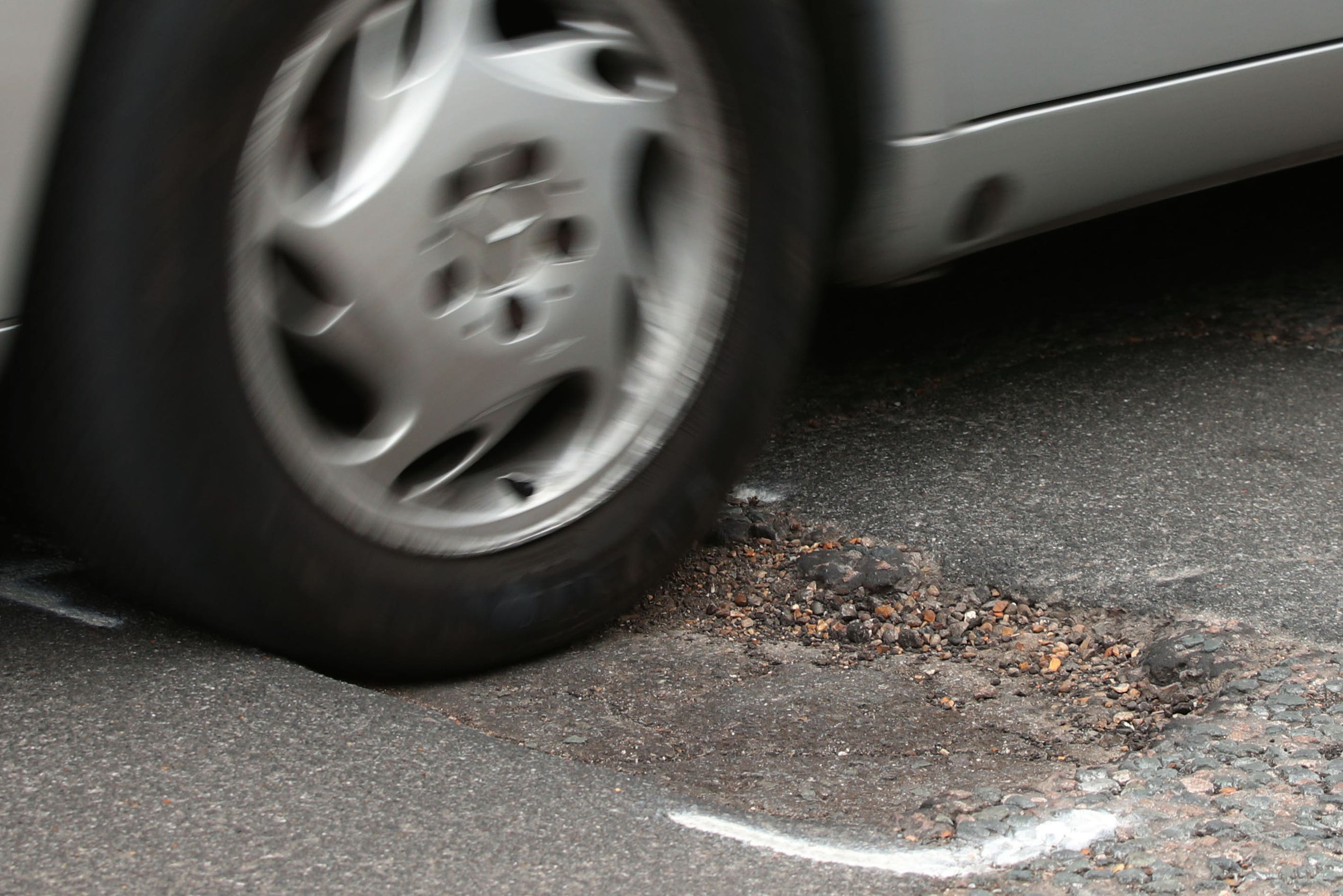 Drivers are being urged to report every road surface crack ‘no matter how small’ amid a surge in pothole-related breakdowns (Yui Mok/PA)