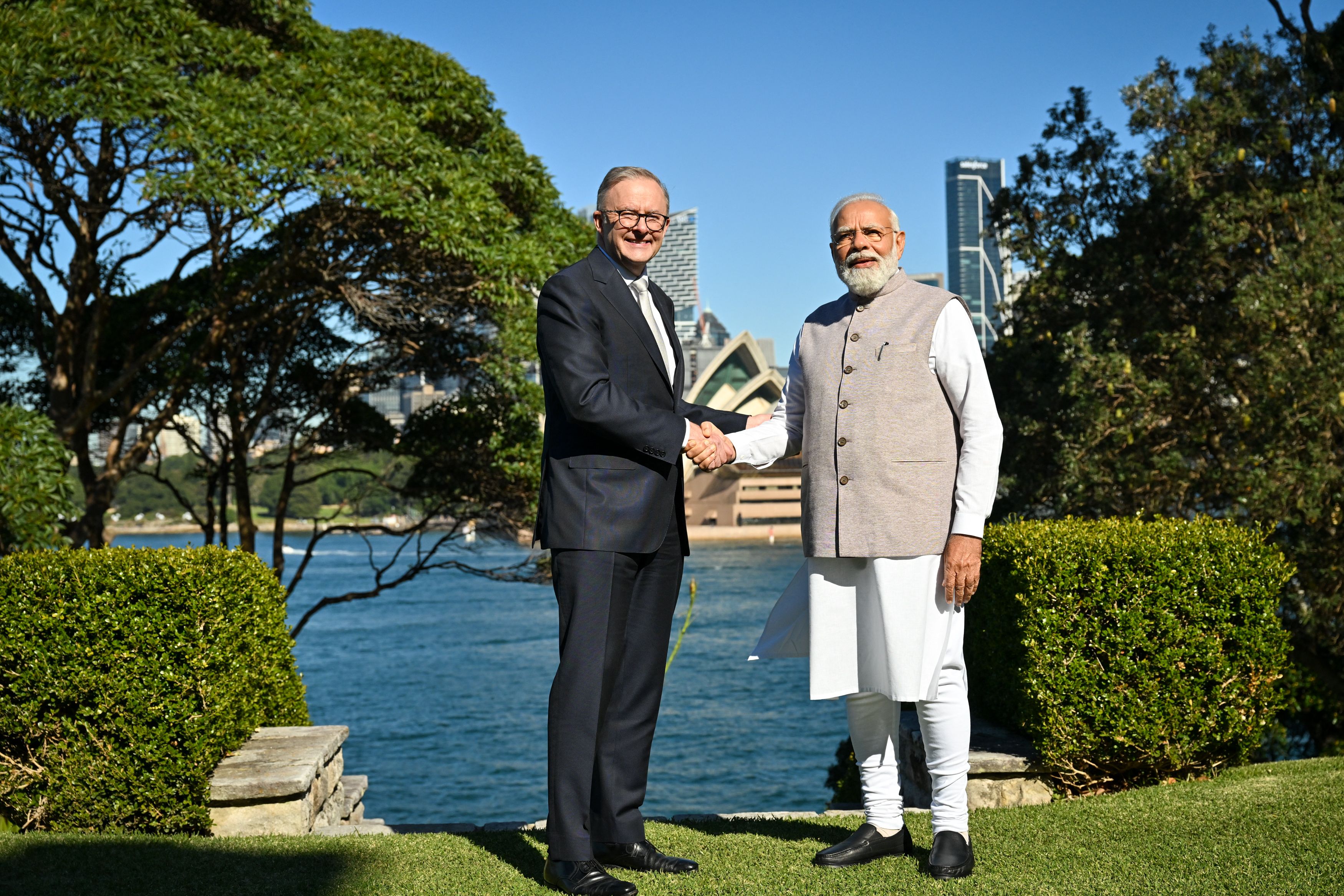 India's Prime Minister Narendra Modi (R) shakes hands with Australia's Prime Minister Anthony Albanese in front of the Sydney Opera House