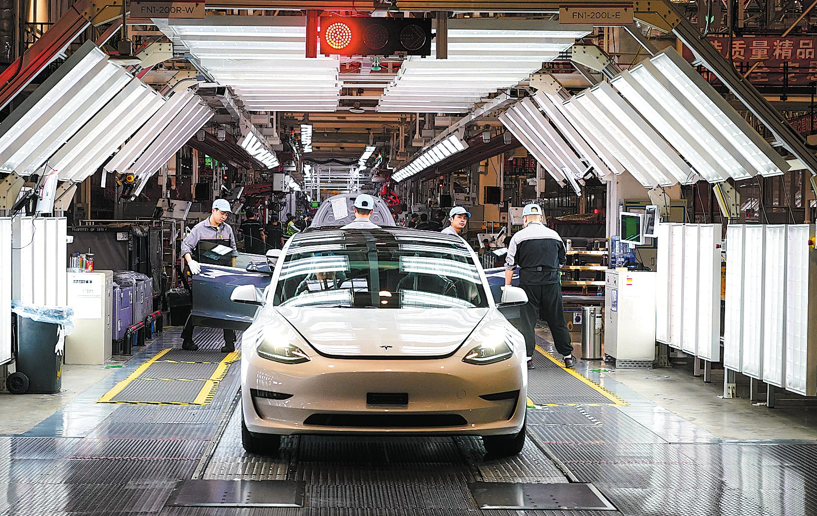 Workers put final touches to a vehicle at Tesla’s gigafactory in Shanghai.