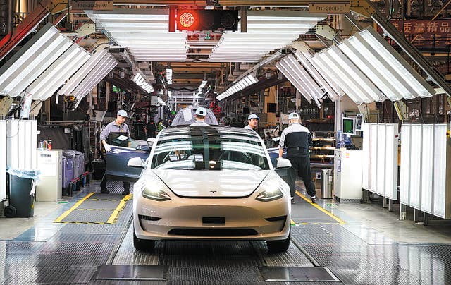 <p>Workers put final touches to a vehicle at Tesla’s gigafactory in Shanghai. </p>