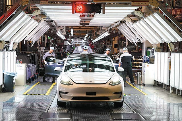 <p>Workers put final touches to a vehicle at Tesla’s gigafactory in Shanghai. </p>
