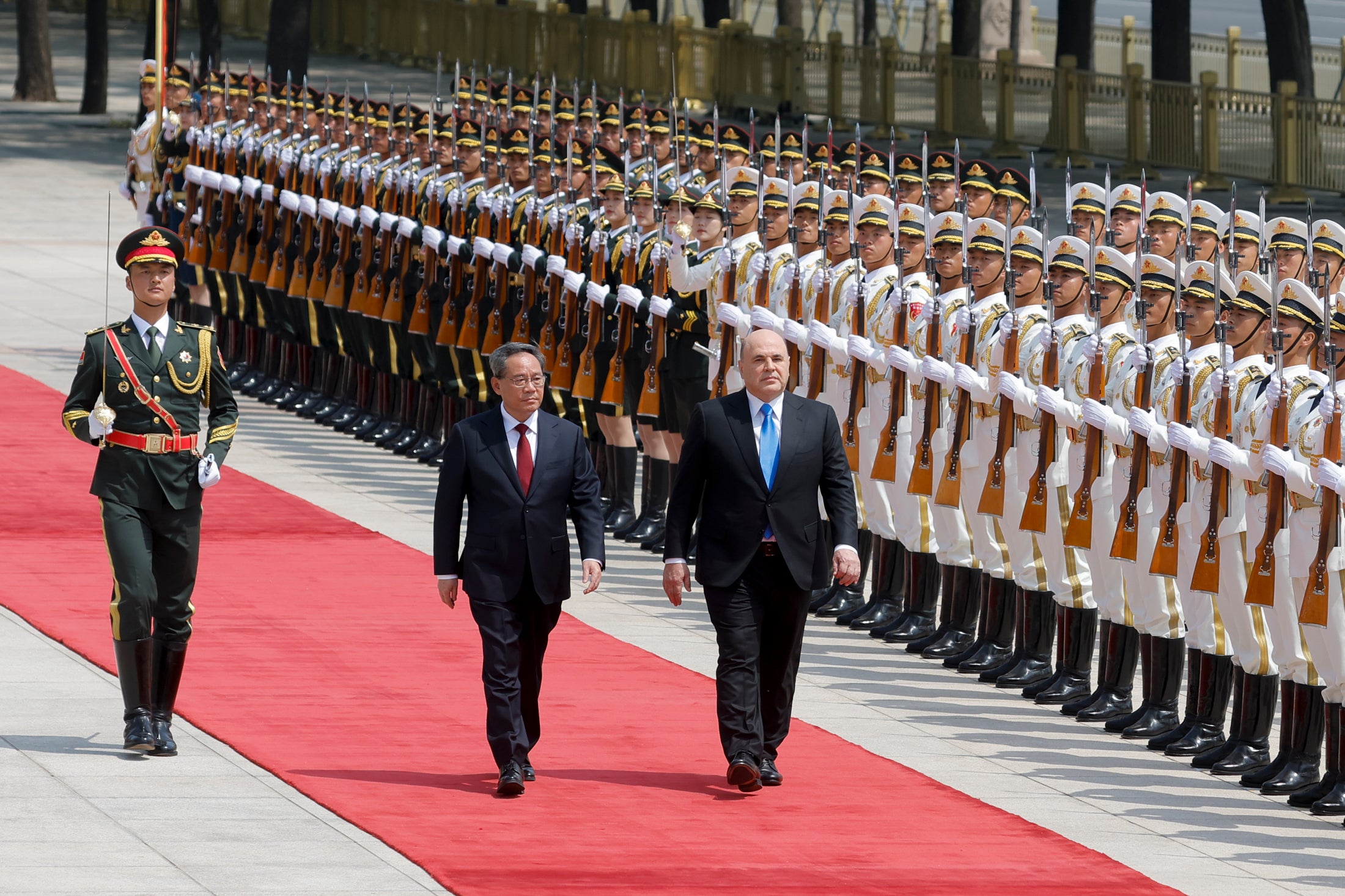 Russian prime minister Mikhail Mishustin (right) and Chinese premier Li Qiang attend a welcoming ceremony in Beijing, China