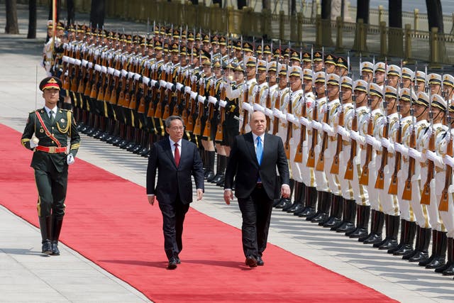 <p>Russian prime minister Mikhail Mishustin (right) and Chinese premier Li Qiang attend a welcoming ceremony in Beijing, China</p>