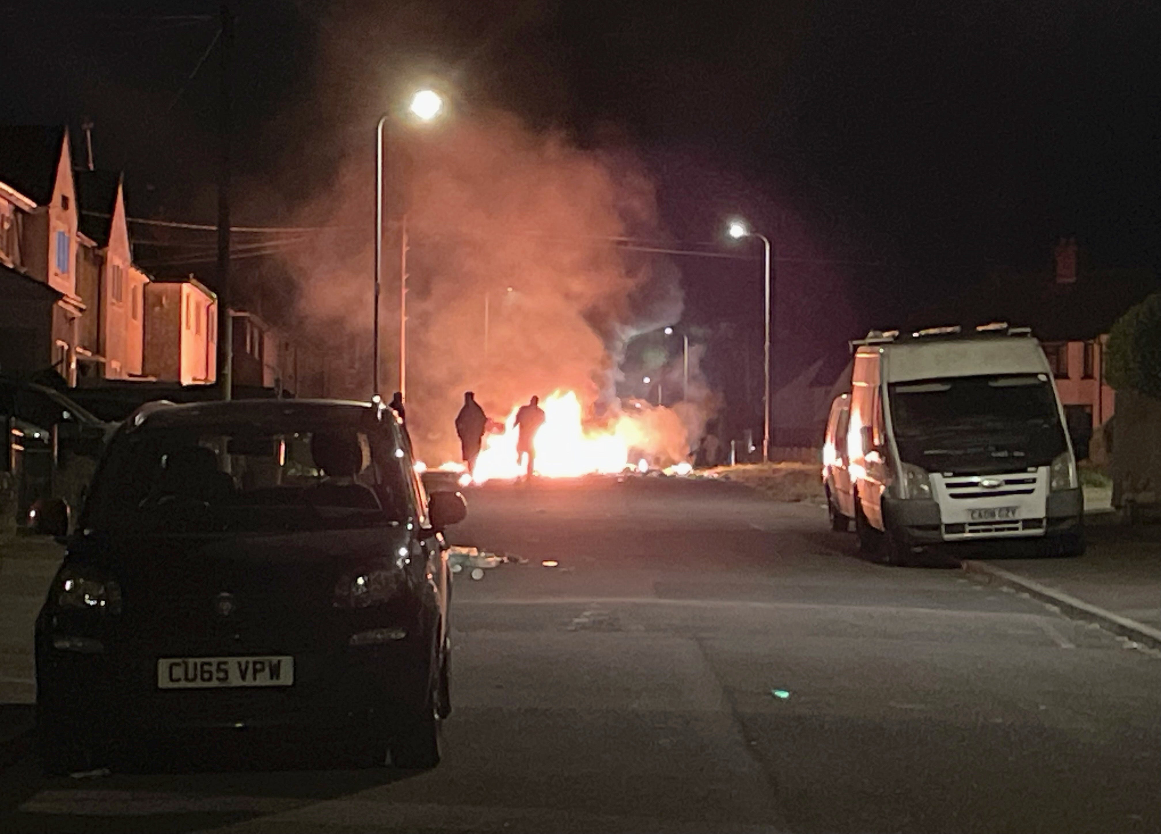 A Ford Focus set alight on Highmead Road, Ely during the disorder
