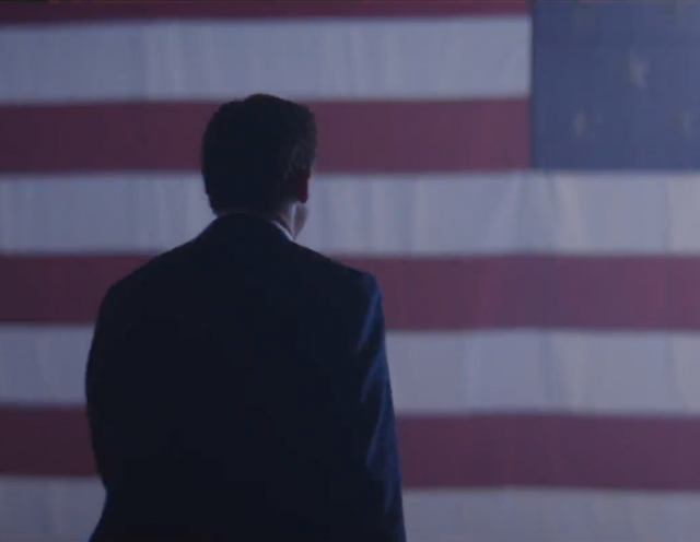 <p>Gov Ron DeSantis of Florida walks toward a US flag in a campaign video</p>