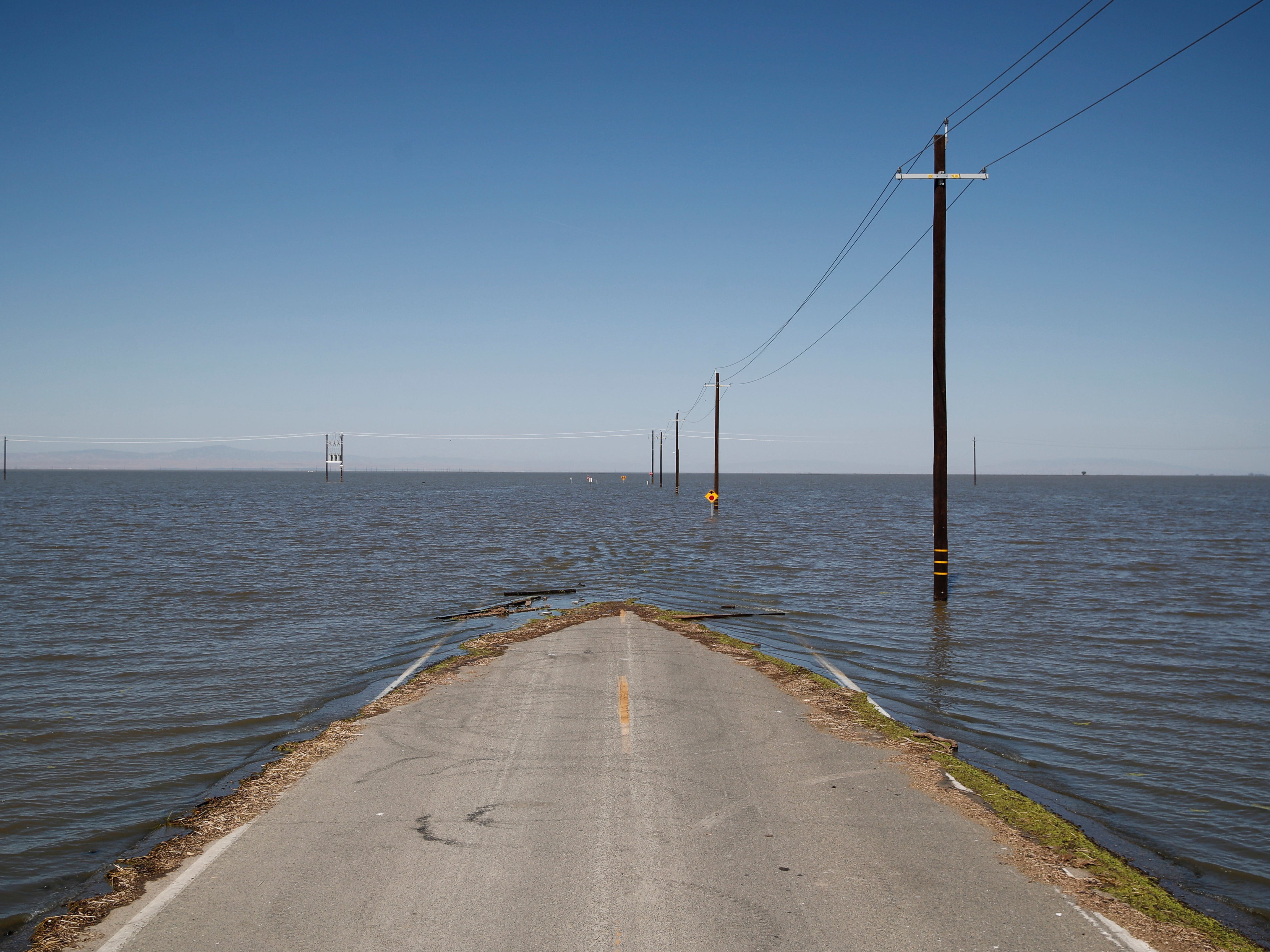 Water from the re-emerging Tulare Lake engulfs a road in Helm Corner