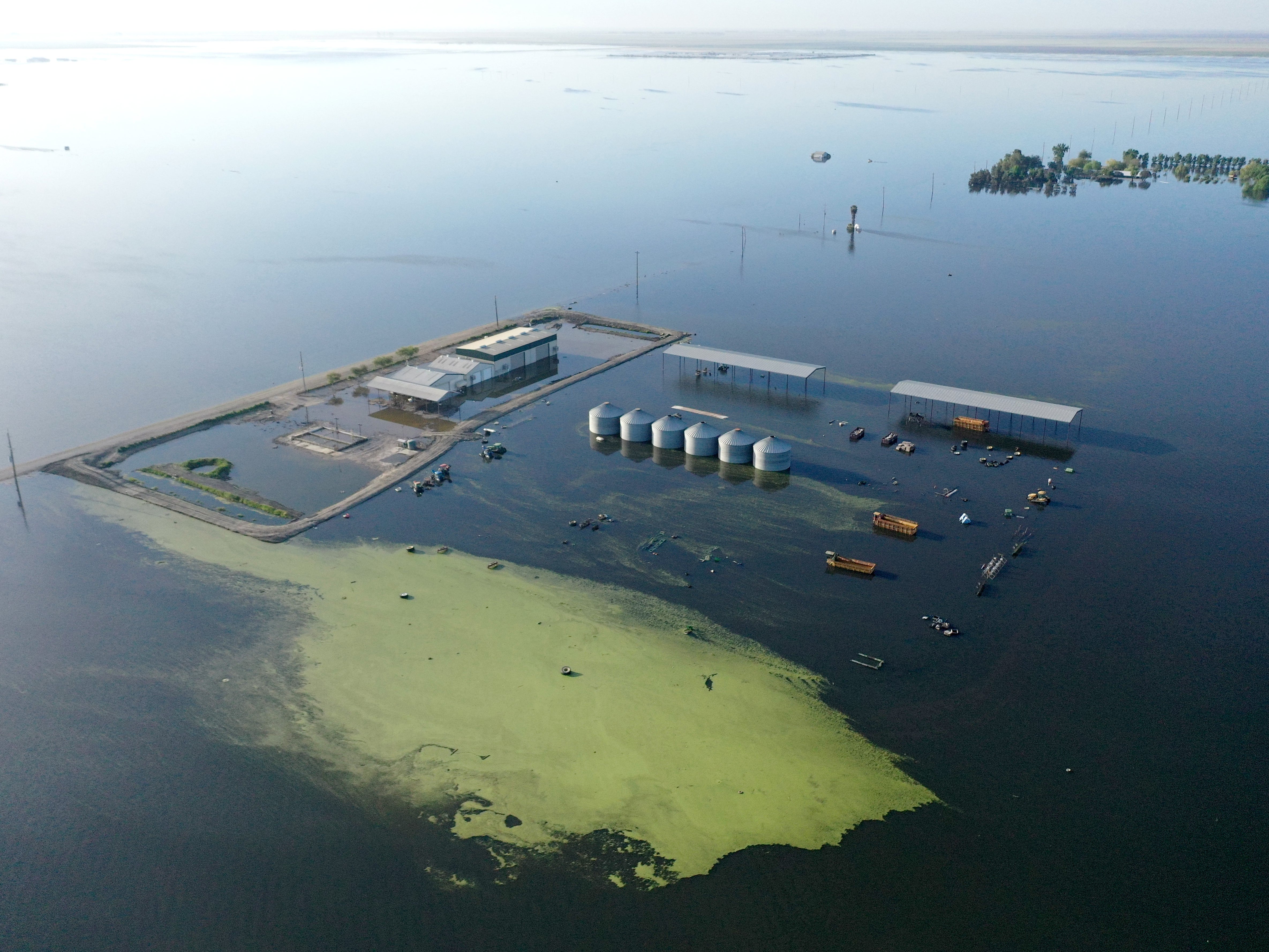 <p>An aerial view of floodwaters inundating farmland in the reemerging Tulare Lake, in California(Photo by Mario Tama/Getty Images)</p>