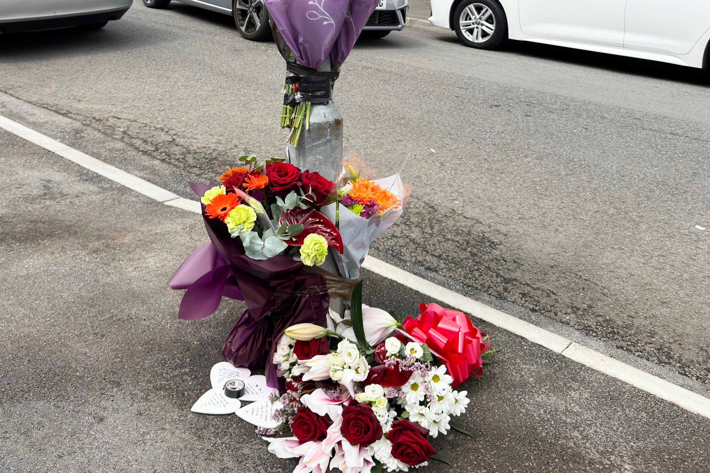 Flowers and tributes left for the two teenagers in Ely, Cardiff, whose deaths in a crash sparked a riot (PA)