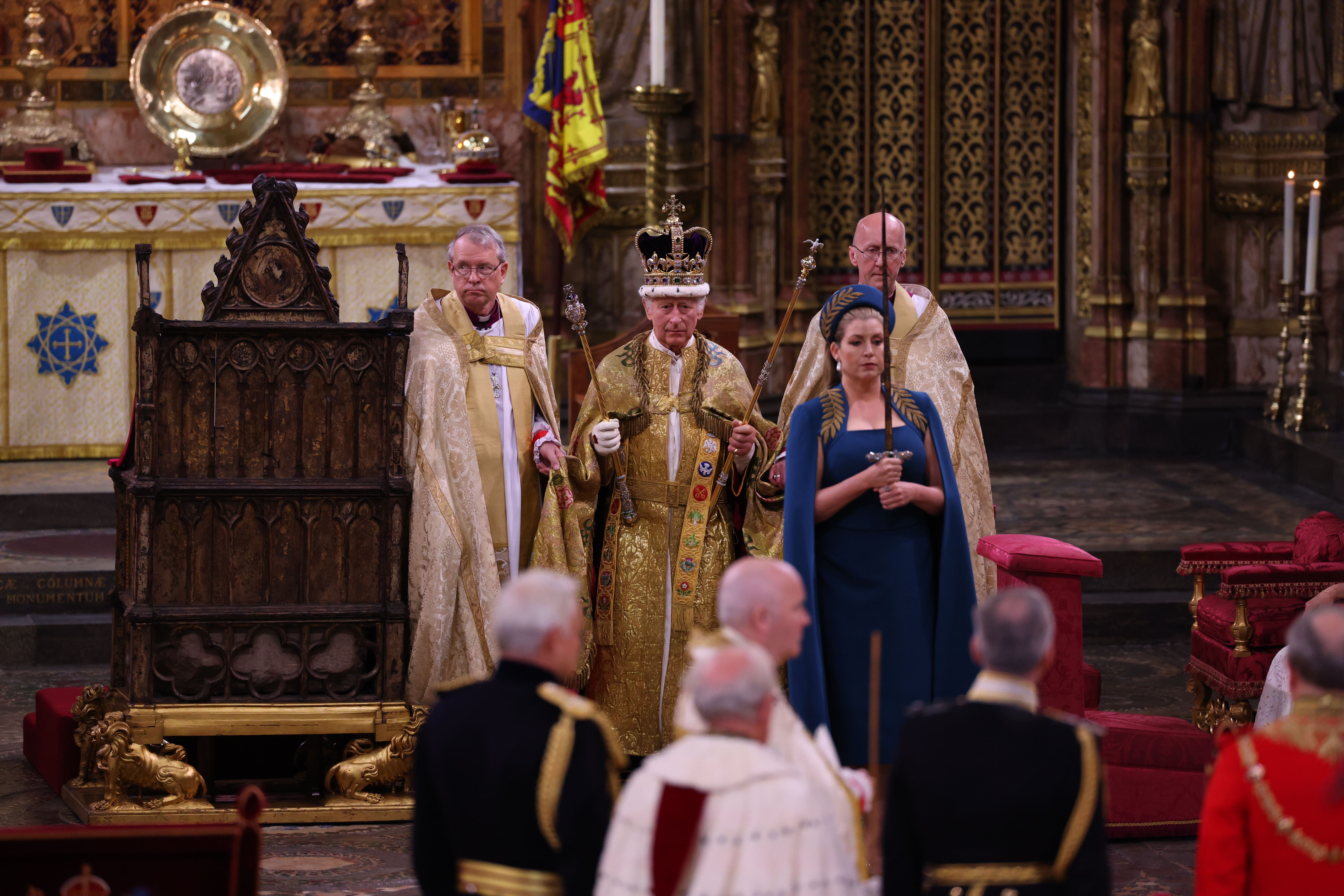 The King with Lord President of the Council, Penny Mordaunt, carrying the Sword of State, during his coronation at Westminster Abbey (Richard Pohle/The Times/PA)