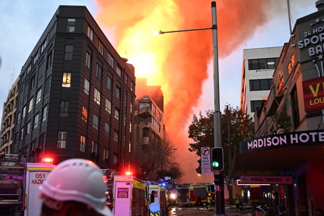 <p>Emergency services work as smoke rises from a building fire in the Central Business District of Sydney</p>