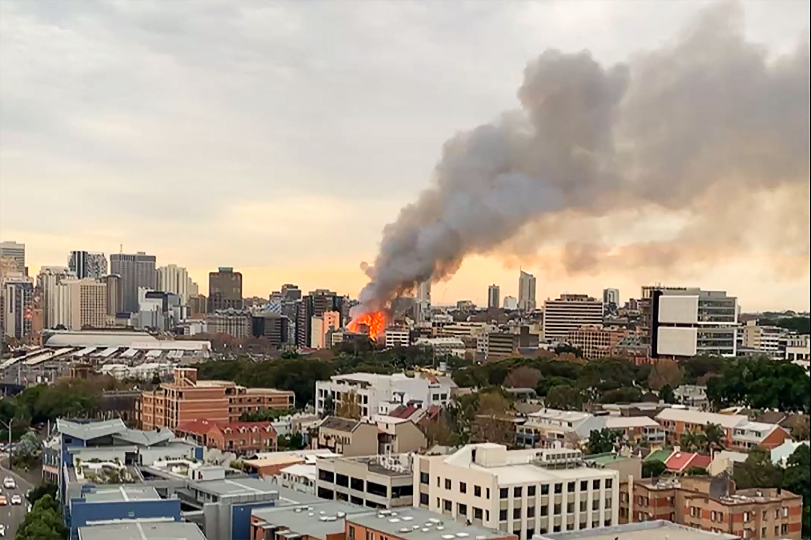 Smoke seen rising into the sky as massive fire engulfs two buildings in central Sydney