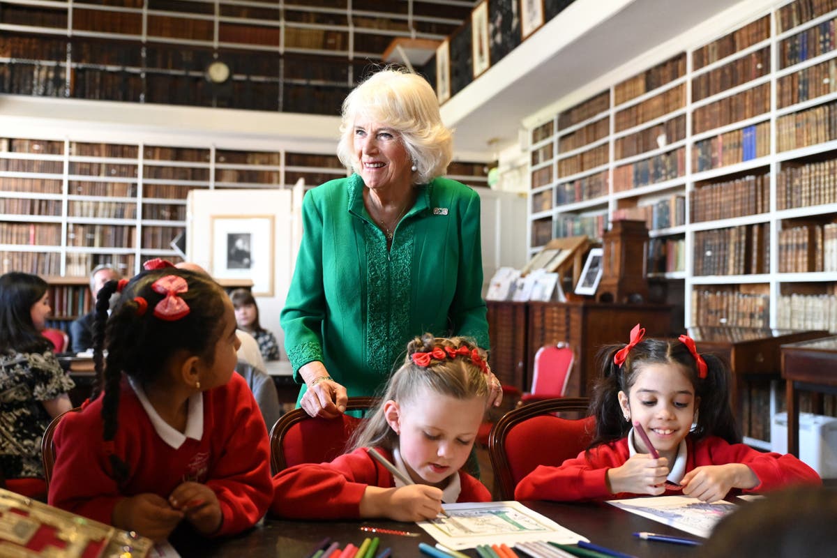 Queen Camilla meets children and volunteers at historic library