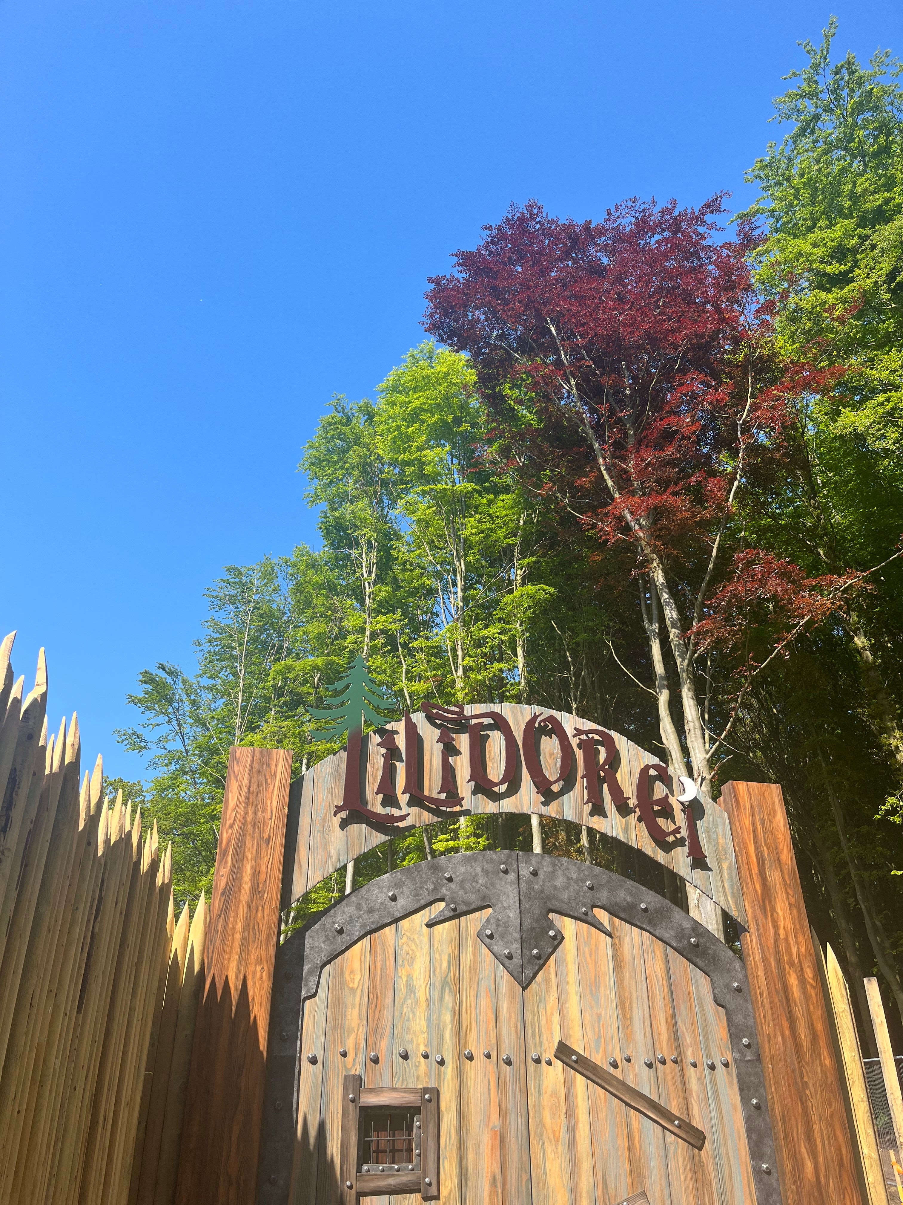 A medieval-style gate signals the start of the play village at Lilidorei