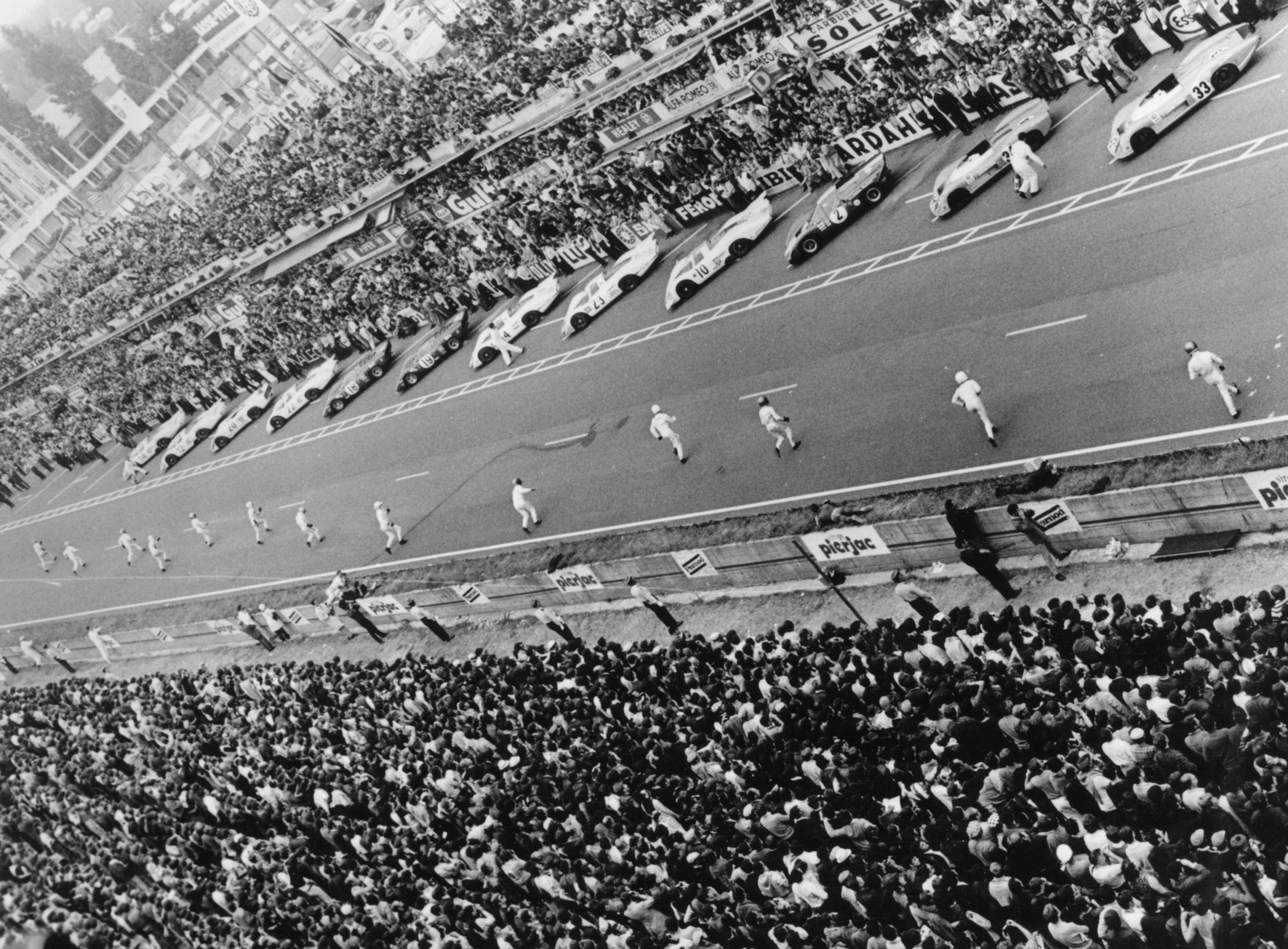 The crowd watches as drivers run to their cars at the start of the 1969 race