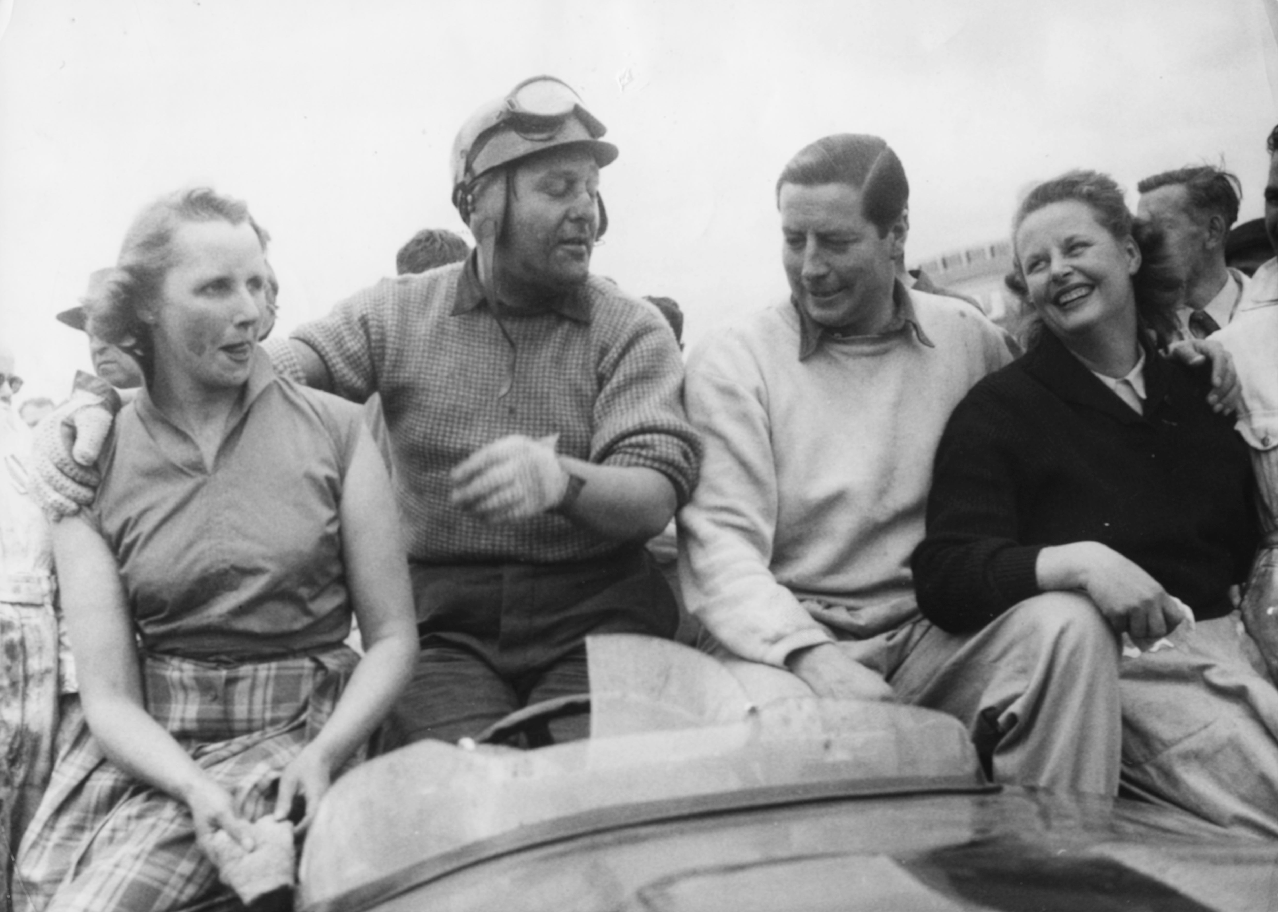 Racing drivers Tony Rolt (left) and Duncan Hamilton with their wives following their victory in 1953