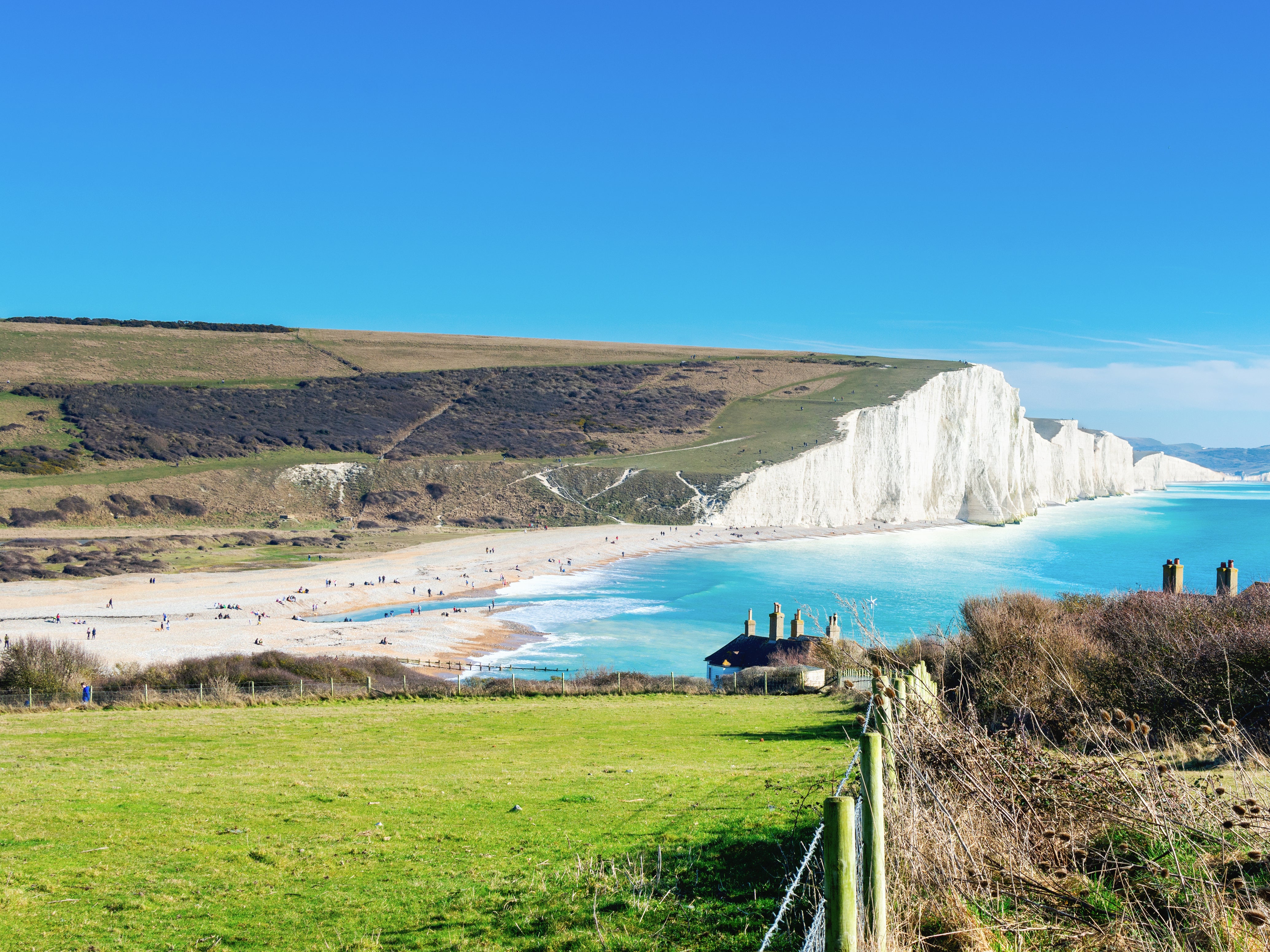 Soak up the views of the white chalk cliffs while walking down to Cuckmere Haven Beach