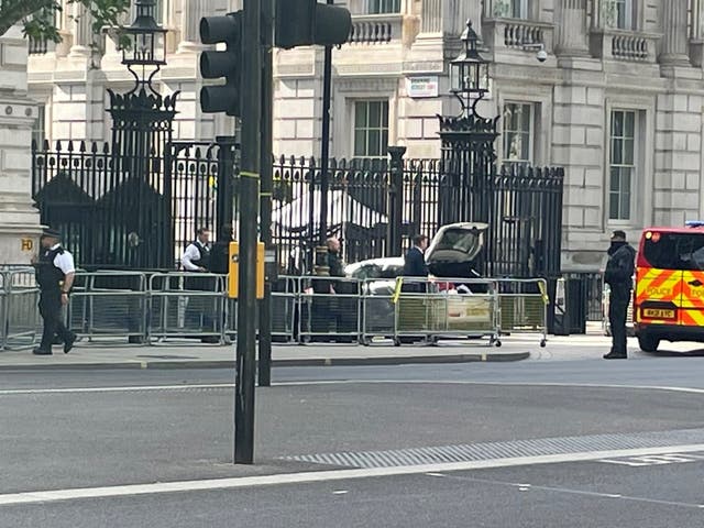 <p>Police at the scene after a car collided with the gates of Downing Street in London. The Metropolitan Police said armed officers have arrested a man on suspicion of criminal damage and dangerous driving. Picture date: Thursday May 25, 2023</p>