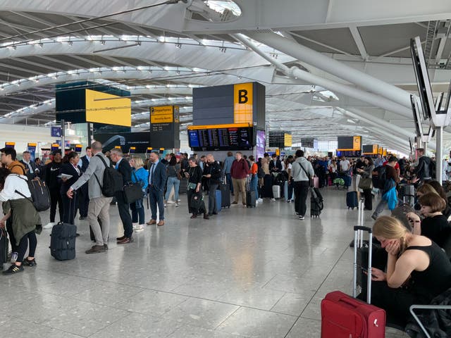 <p>Long lines of British Airways passengers waiting to be rebooked at Heathrow after mass cancellations on Thursday</p>