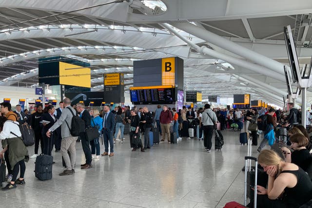 <p>Passengers waiting to be rebooked at Heathrow after mass cancellations</p>