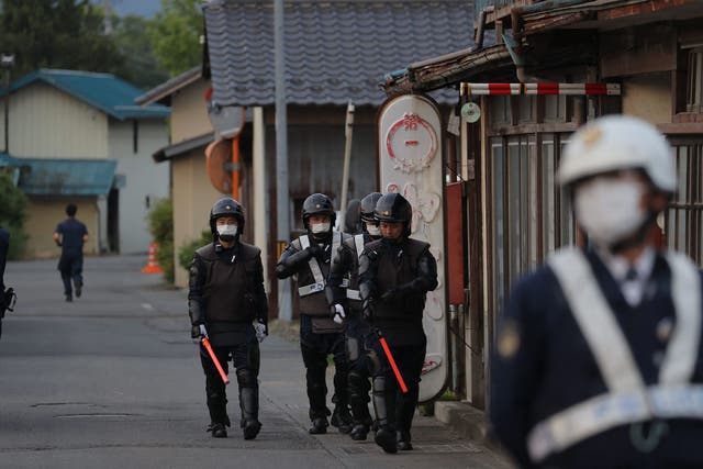 <p>Japanese police officers are seen near the scene of a standoff where a suspect was holed up inside a building </p>