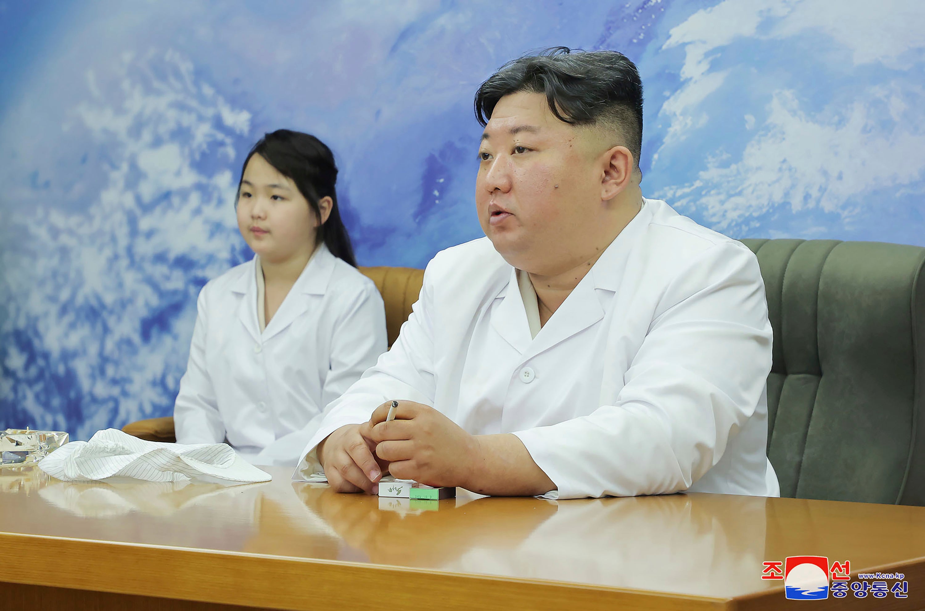 North Korean leader Kim Jong-un, right, and his daughter, Kim Ju-ae, visit the country's aerospace agency on Tuesday