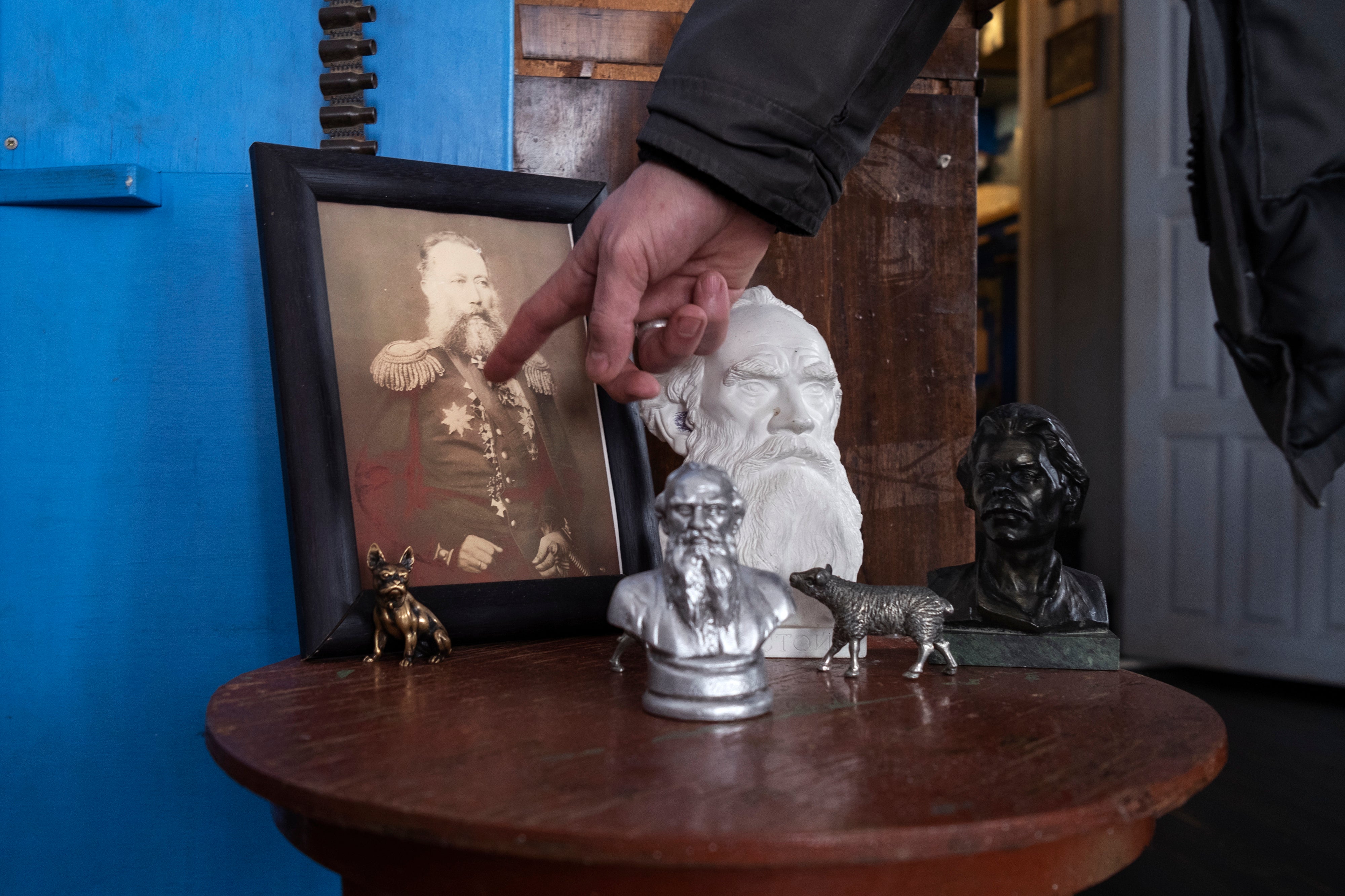 Akimov points to a photo of his grandfather who served in the tsar’s army and participated in the Caucasian War