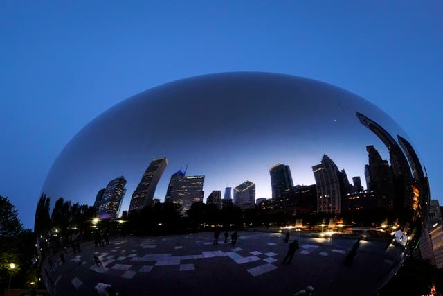 <p>The Chicago skyline is reflected on Anish Kapoor’s stainless steel sculpture Cloud Gate, also known as  ‘The Bean’ </p>
