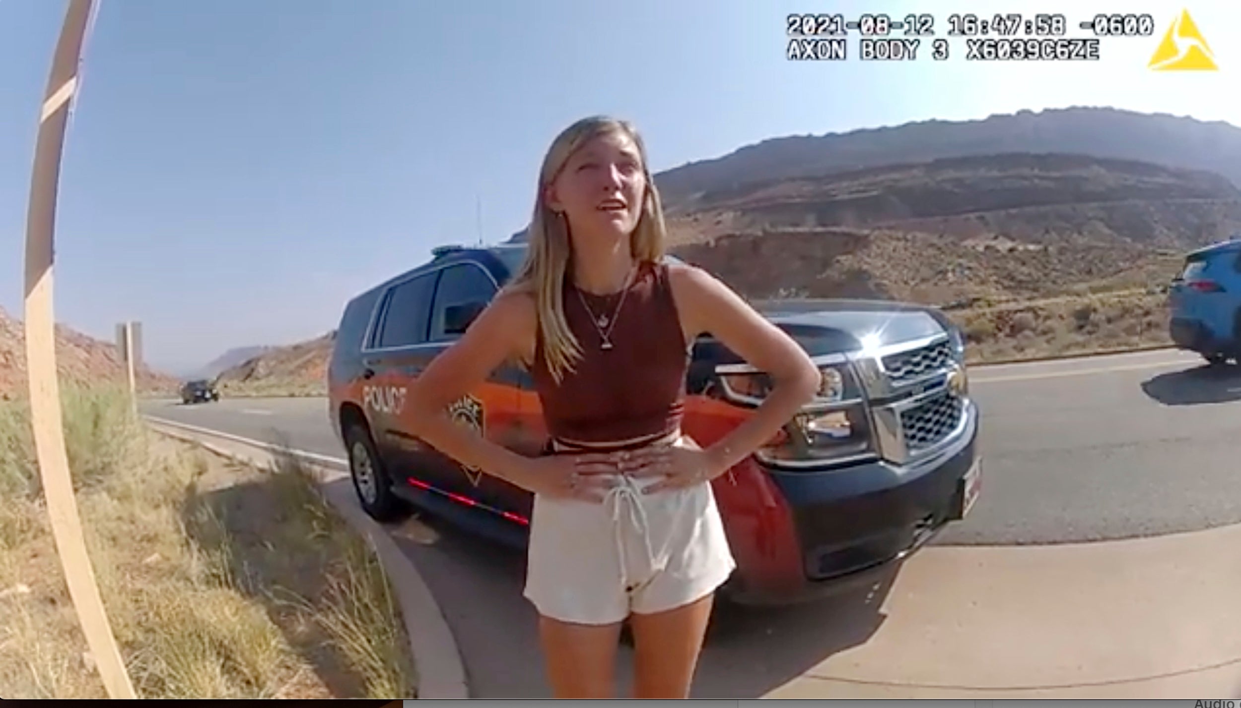 In this image taken from police body camera video provided by the Moab Police Department, Gabrielle Petito talks to a police officer after police pulled over the van she was traveling in with her boyfriend, Brian Laundrie, near the entrance to Arches National Park on Aug. 12, 2021