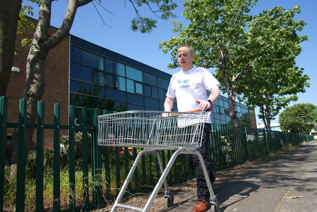 Canon Gavin Kibble MBE with a shopping trolley (Chalmers News PR/PA)