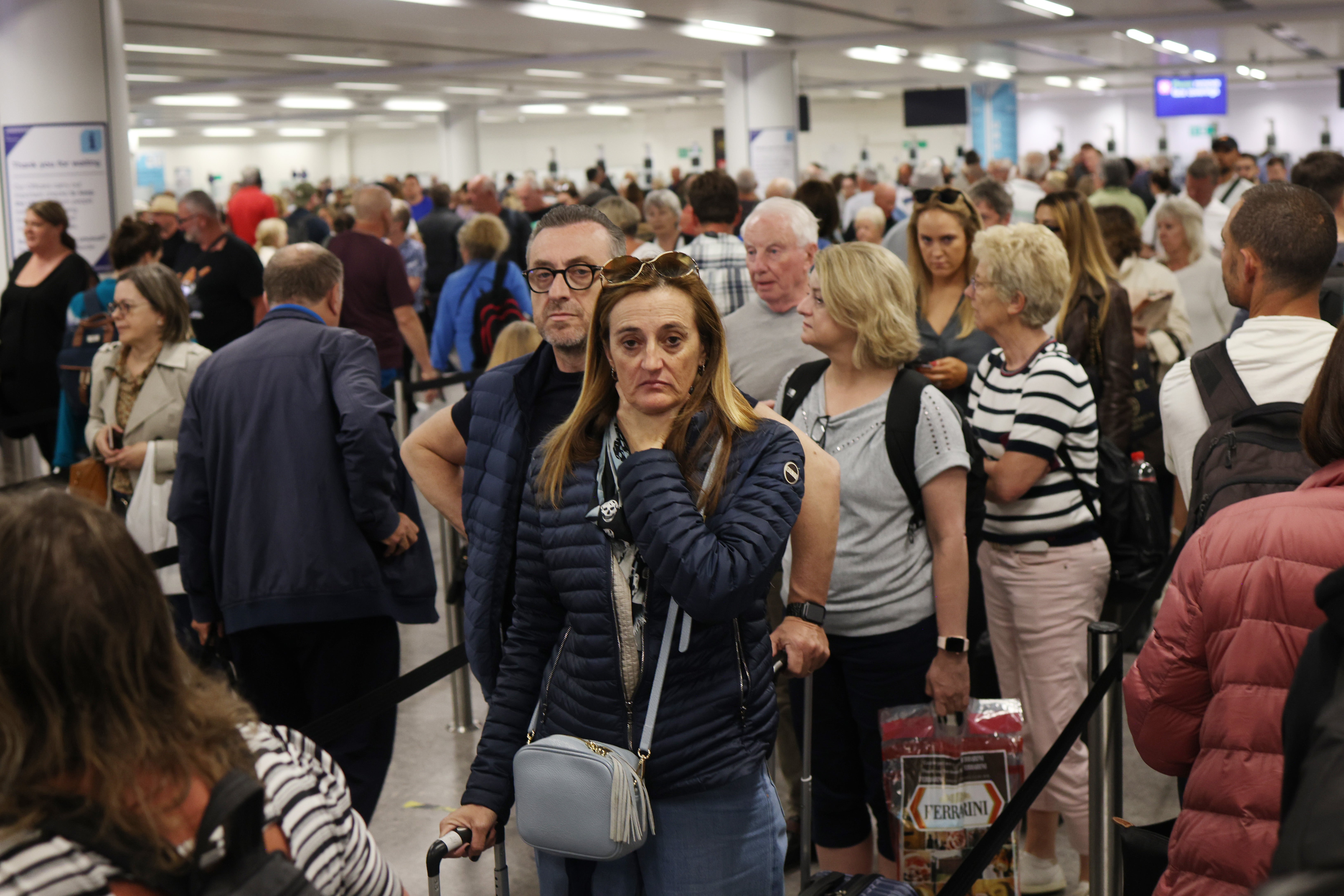 <p>Passengers queue at Gatwick Airport as electronic passport gates fail across the UK</p>