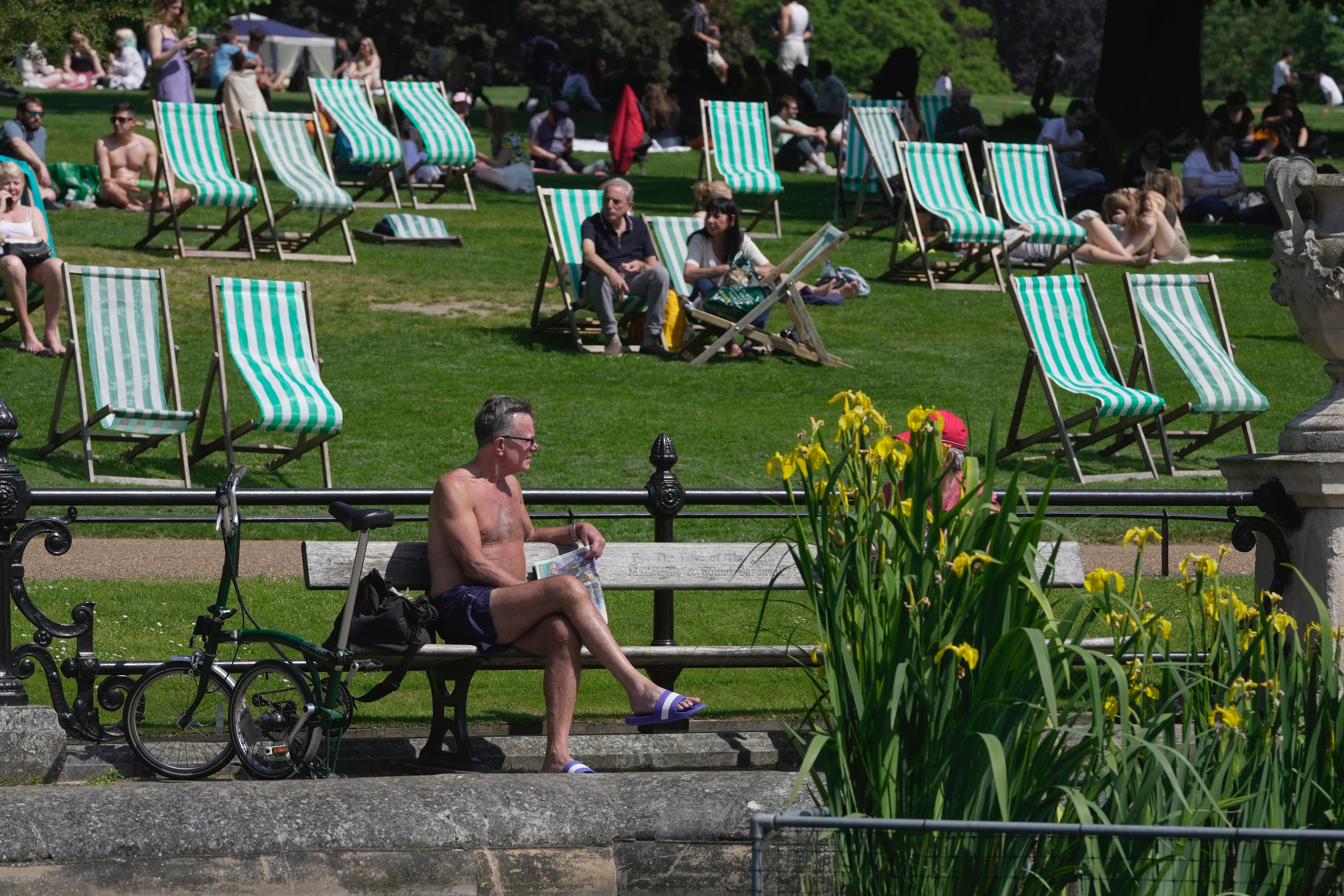 People enjoy the sunny weather at a park in London on Sunday