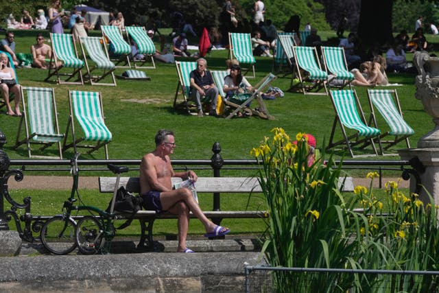 <p>People enjoy the sunny weather at a park in London on Sunday </p>