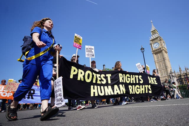 People march past the Houses of Parliament during a Not My Bill protest in London (James Manning/PA)