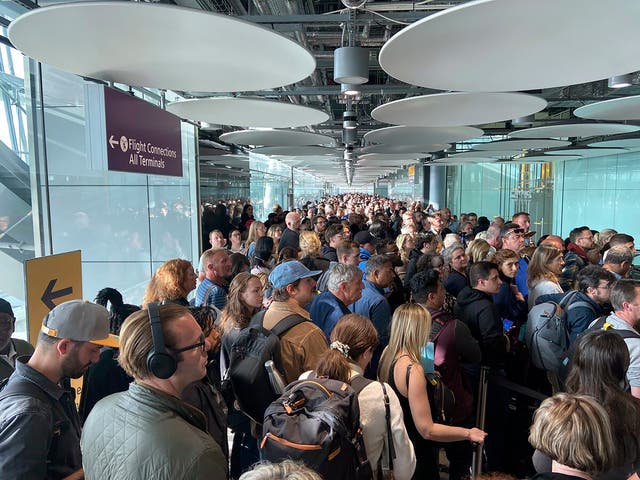 <p>People queue at arrivals at Heathrow airport in London on Saturday</p>